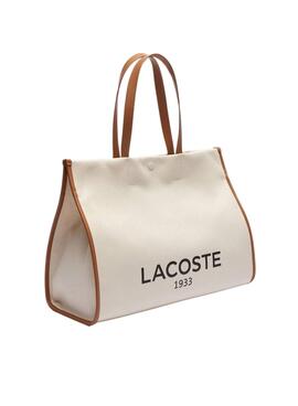 Sac fourre-tout Lacoste en toile beige de grande taille.